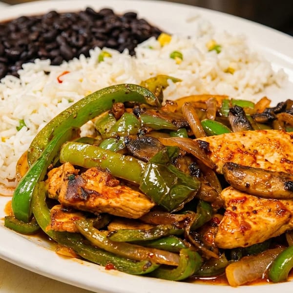 Grilled chicken with sautéed peppers and mushrooms, alongside white rice and black beans.
